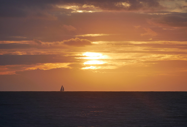 A yacht sailing over the horizon