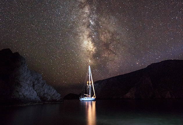A yacht anchored underneath the night sky