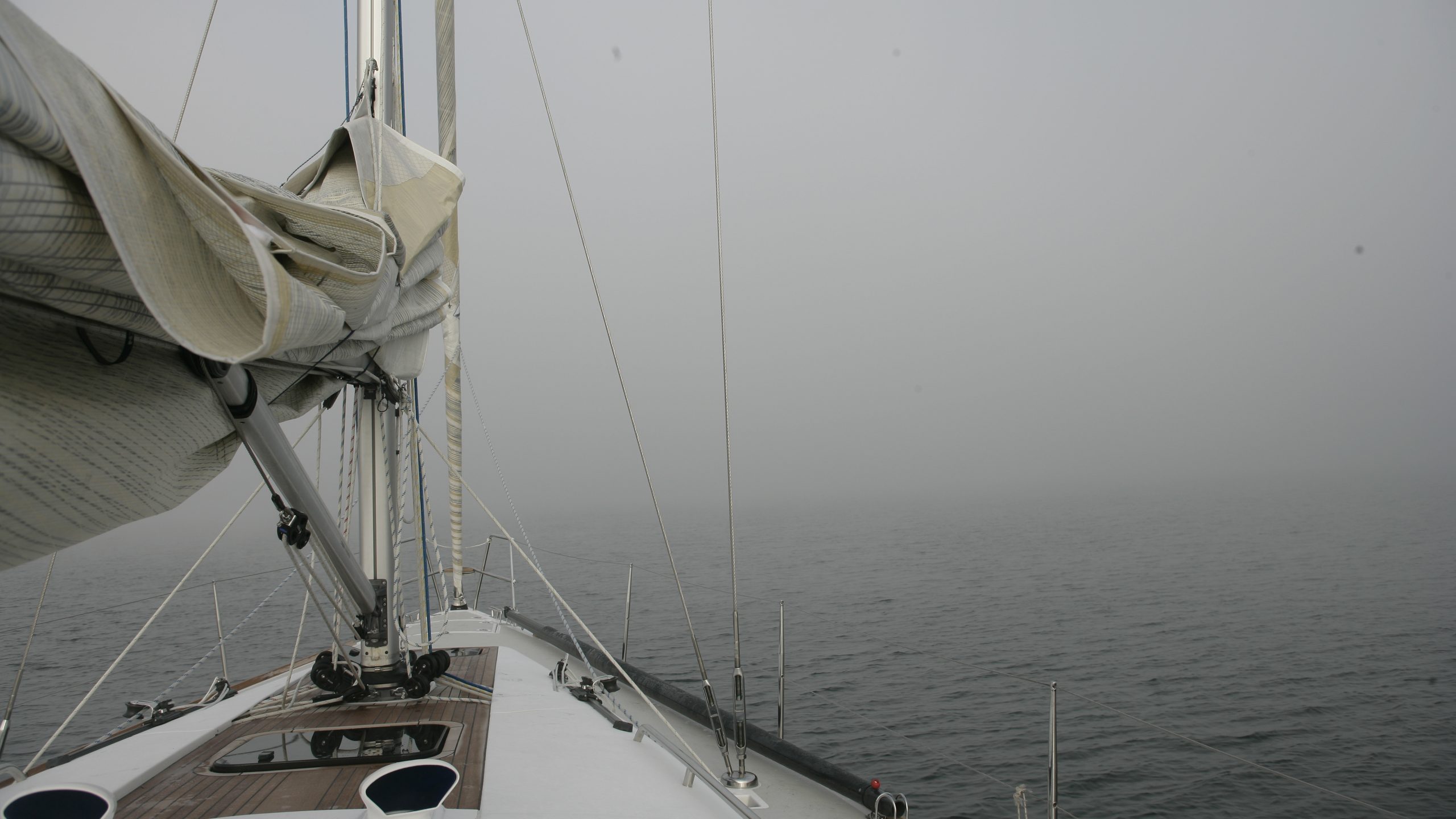 A boat sailing towards a tidal headland in poor visibility with no working engine or electrics