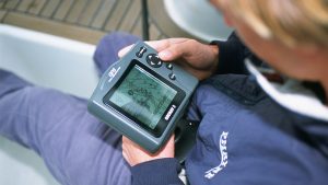 GPS failure: a man looking at a GPS on a boat