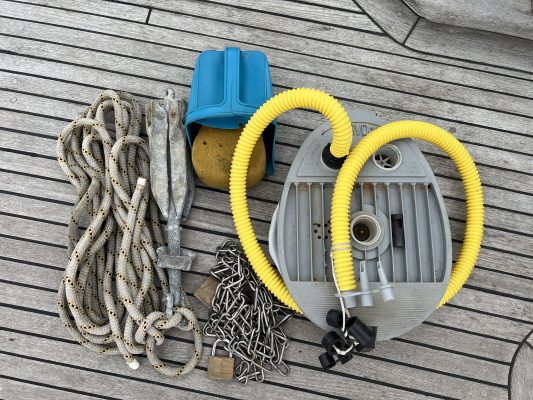 A pump for a dinghy with a yellow hose