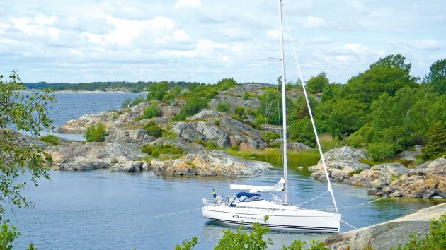 A yacht moored to rocks while sailing the Baltic Sea