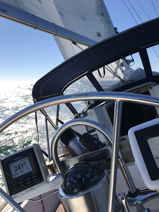 A yacht sailing in heavy weather with boat steering failure